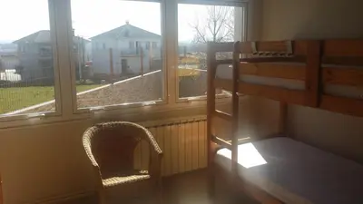 a room with a bunk bed and a window at Albergue Ultreia in Arzúa