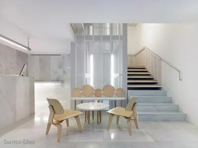 a room with two chairs and a table and stairs at Hotel Pazo de Altamira in Santiago de Compostela