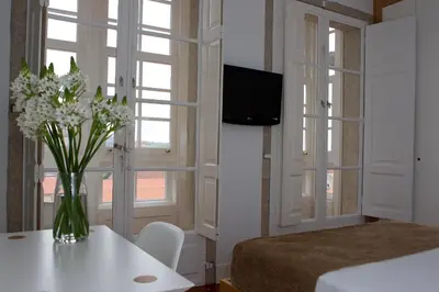 a bedroom with a vase of flowers on a table at Hotel Pazo de Altamira in Santiago de Compostela
