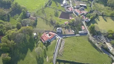 an aerial view of a house in a field at Hosteria Calixtino in Palas de Rei