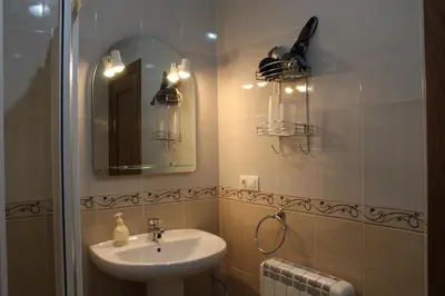 a bathroom with a sink and a mirror at Apartamentos Casa Cerolleiro in Castropol