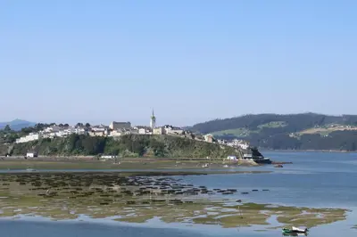 a small island in the middle of a body of water at Apartamentos Casa Cerolleiro in Castropol