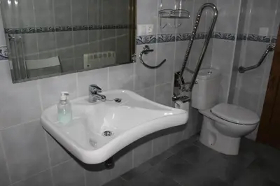 a bathroom with a sink and a toilet at Apartamentos Casa Cerolleiro in Castropol