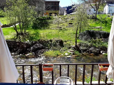 a view of a river from a balcony at Las Rocas in Vega de Valcarce