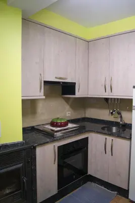 a kitchen with white cabinets and a sink at Casa Gelita in Casayo