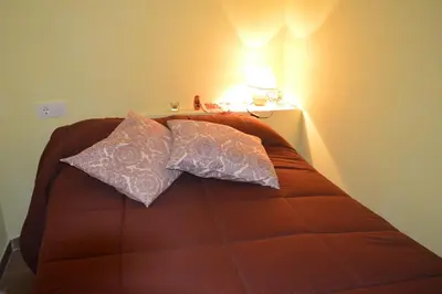 a bed with two pillows on it in a room at Casa Gelita in Casayo