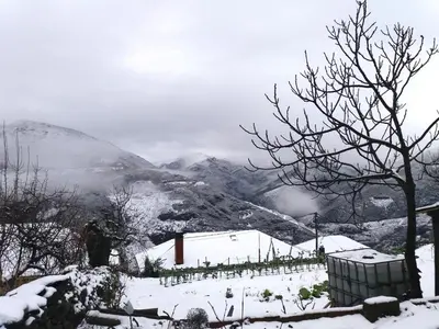 a snow covered hill with a mountain in the background at Casa Gelita in Casayo