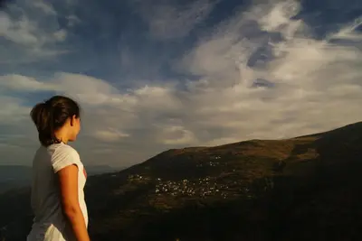 a woman standing on top of a mountain looking at a city at Casa Gelita in Casayo