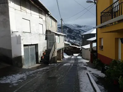 an alley with snow on the ground next to buildings at Casa Gelita in Casayo