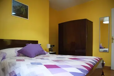 a bedroom with a bed with a purple pillow at Casa Gelita in Casayo
