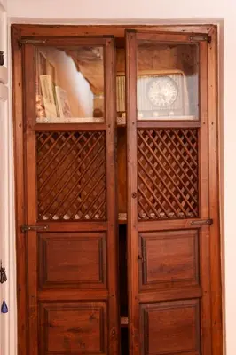 a wooden cabinet with two doors in a room at Casa Pepa Hotel Rural in Santa Colomba de Somoza