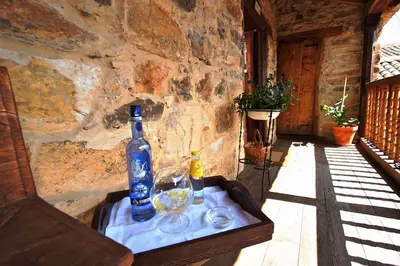 a bottle of wine and glasses on a table at Casa Pepa Hotel Rural in Santa Colomba de Somoza