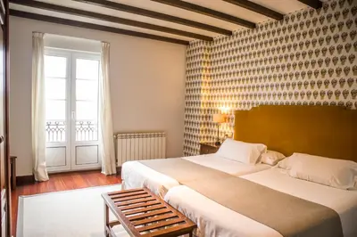 a bedroom with a large bed and a window at Hotel A Casa Do Rio in Padrón