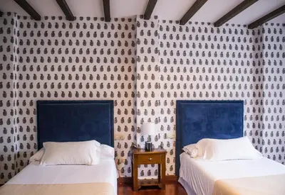 two beds sitting next to each other in a room at Hotel A Casa Do Rio in Padrón