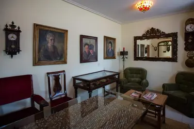 a living room with a table and a mirror at Hotel Los Perales in Puebla de Sanabria
