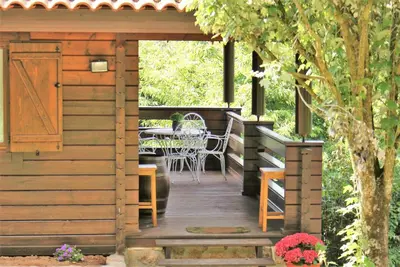 a wooden deck with a table and chairs on it at El Estudio in Ferreirós