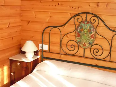 a bedroom with a bed and a table with a lamp at El Estudio in Ferreirós