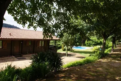 a house with a yard with a pool and trees at El Estudio in Ferreirós