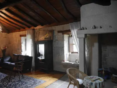 a living room with a couch and a fireplace at San Andres Ferienhaus mit Gästehaus in Parada del Sil