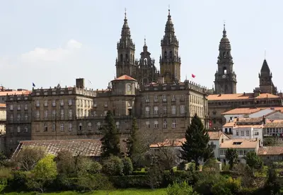 a large building with two towers in a city at Hotel Pazos Alba in Santiago de Compostela