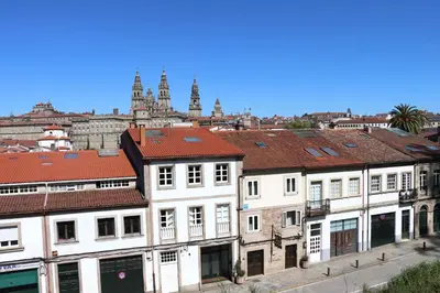 a group of buildings with a city in the background at Hotel Pazos Alba in Santiago de Compostela