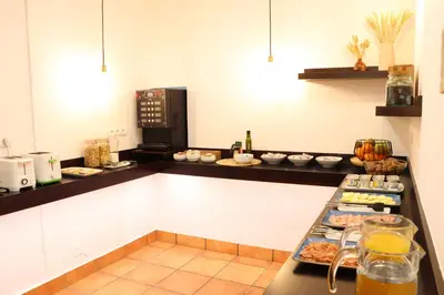 a kitchen with a counter with food on it at Hotel Pazos Alba in Santiago de Compostela
