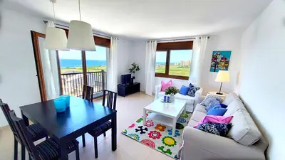 a living room with a table and a dining room at Masquestar Rías Altas in Foz