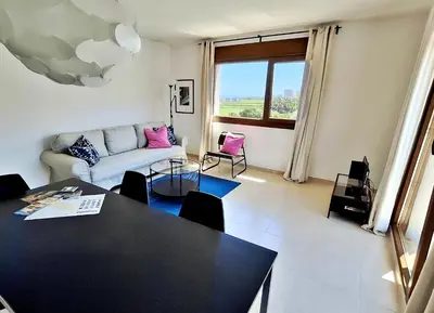 a living room with a table and a couch at Masquestar Rías Altas in Foz