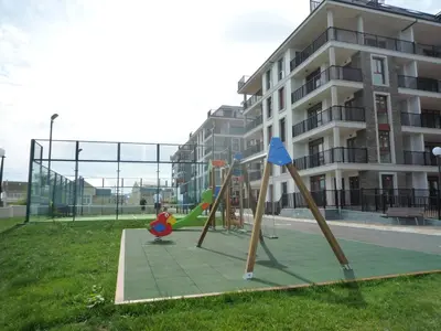 a playground in a park next to a building at Masquestar Rías Altas in Foz