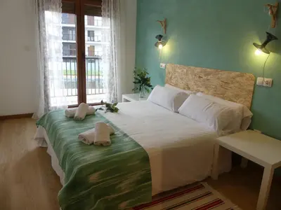 a bedroom with a large bed with towels on it at Masquestar Rías Altas in Foz