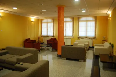a waiting room with couches and chairs at Hotel Meleiros in Castro de Sanabria
