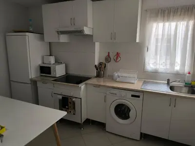 a kitchen with a sink and a washing machine at Piso Ponferrada in Ponferrada