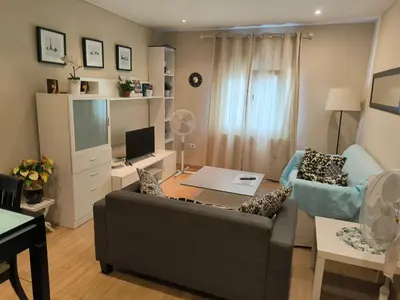 a living room with a couch and a television at Piso Ponferrada in Ponferrada