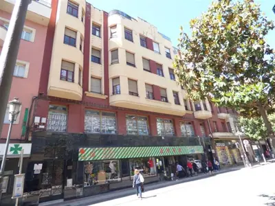 a person walking down a street in front of a building at Piso Ponferrada in Ponferrada
