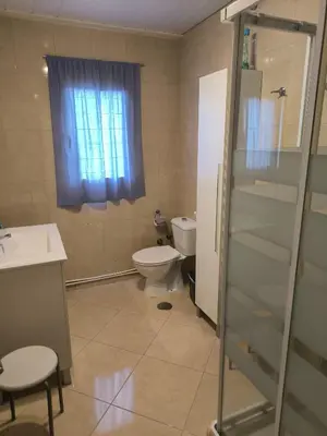 a bathroom with a toilet and a glass shower at Piso Ponferrada in Ponferrada
