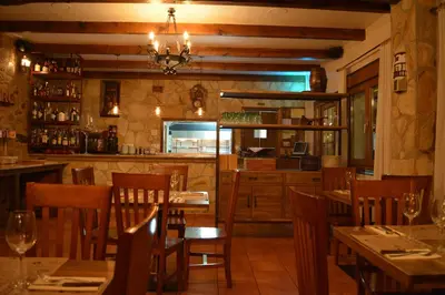 a restaurant with wooden tables and chairs and a bar at Hotel Casa Reboiro in Monforte de Lemos