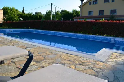 a swimming pool in a yard with a house at Hotel Casa Reboiro in Monforte de Lemos