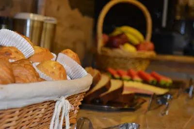 a basket of bread and fruit on a table at Hotel Casa Reboiro in Monforte de Lemos