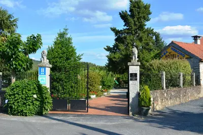 a gate to a garden with statues on it at Hotel Casa Reboiro in Monforte de Lemos