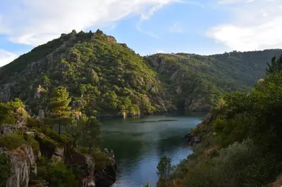 a river in the middle of a mountain at Hotel Casa Reboiro in Monforte de Lemos