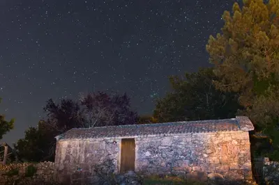 an old stone building under a night sky with stars at Veiga Mariña in Pontevedra