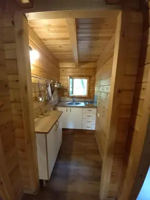 a kitchen in a log cabin with a sink at Veiga Mariña in Pontevedra