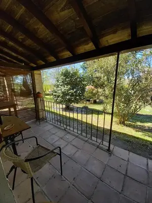 a screened in porch with a table and a chair at Veiga Mariña in Pontevedra