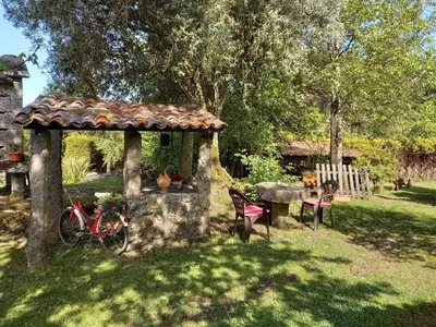 a gazebo in a yard with a table and a bike at Veiga Mariña in Pontevedra