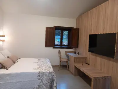 a bedroom with a bed and a flat screen tv at Veiga Mariña in Pontevedra