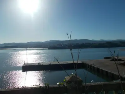 a large body of water with the sun shining on it at Mirador Ría de Ribadeo in Ribadeo