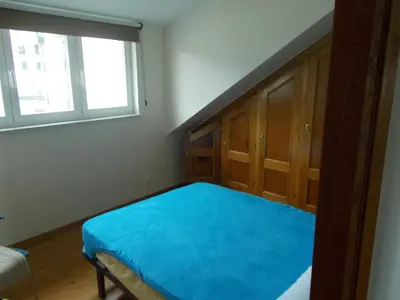 a bedroom with a bed with a blue blanket at Mirador Ría de Ribadeo in Ribadeo