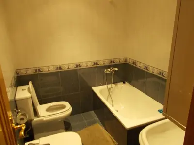 a bathroom with a toilet and a bath tub at Mirador Ría de Ribadeo in Ribadeo