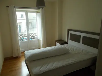 a bedroom with a bed and a large window at Mirador Ría de Ribadeo in Ribadeo