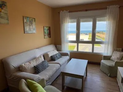 a living room with a couch and a table at Apartamento en playa de Foz in Foz